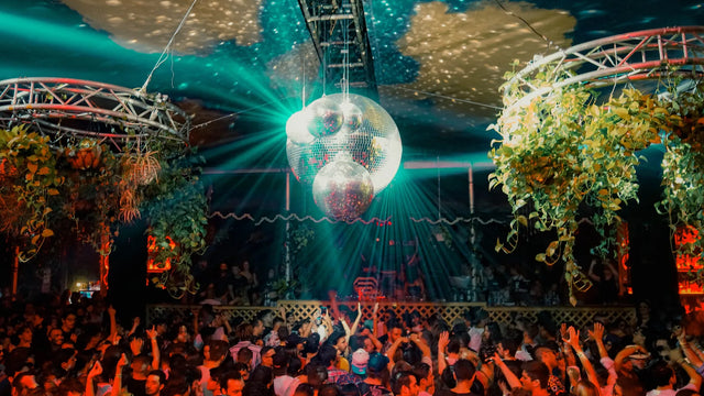 Crowd under a mirror ball and plants on the Terrace at Club Space in Miami in 2019
